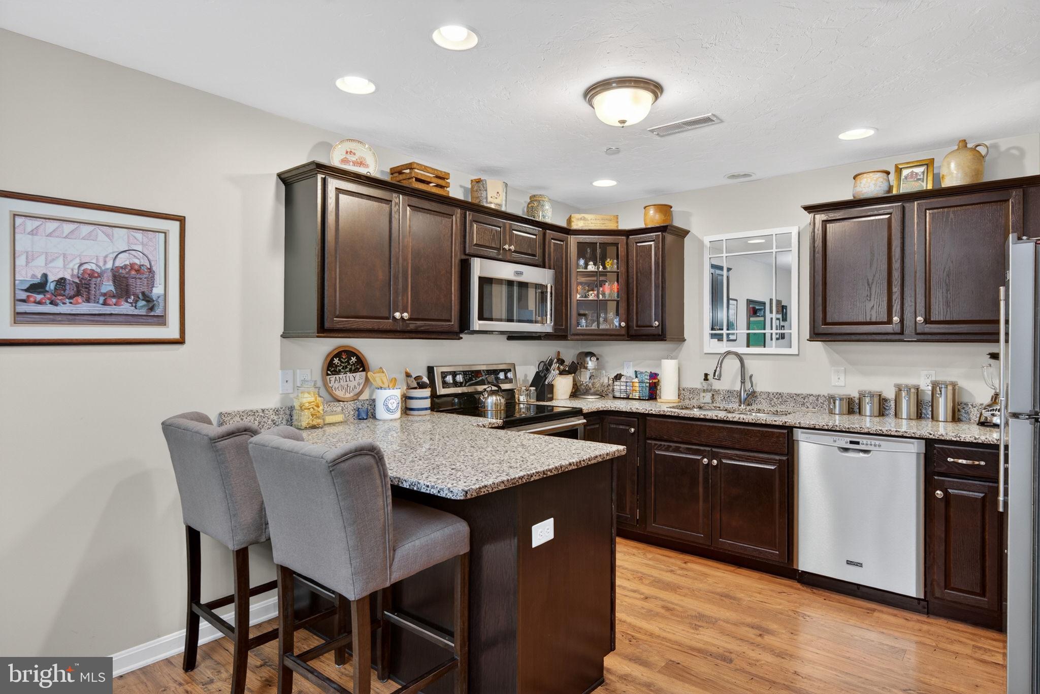 1332 Pleasant View Drive, Unit 75 Spring Grove, PA 17362 - Photo 12 of 26 a kitchen with granite countertop a sink counter top space appliances and cabinets