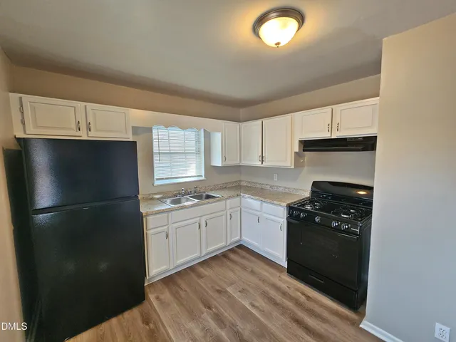 a kitchen with a refrigerator stove and microwave