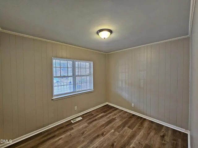 a view of a room with wooden floor and windows
