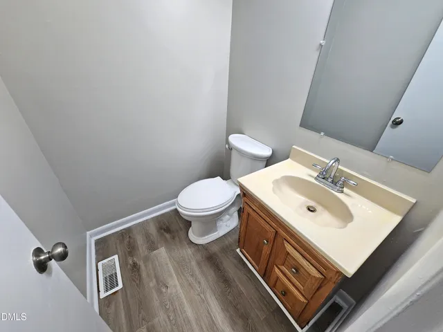 a bathroom with a sink toilet and a mirror