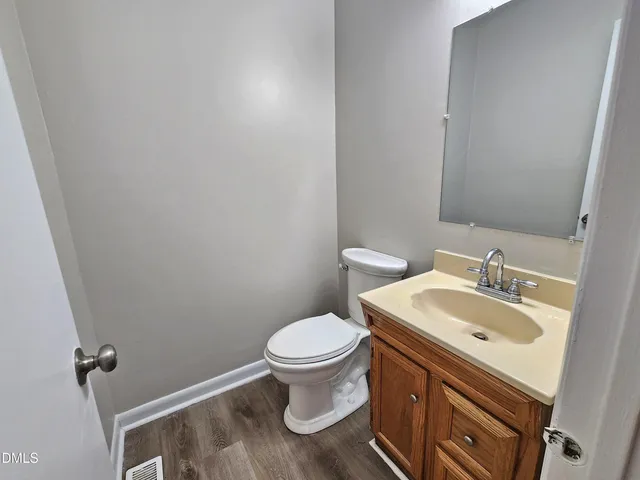 a bathroom with a sink toilet and a mirror