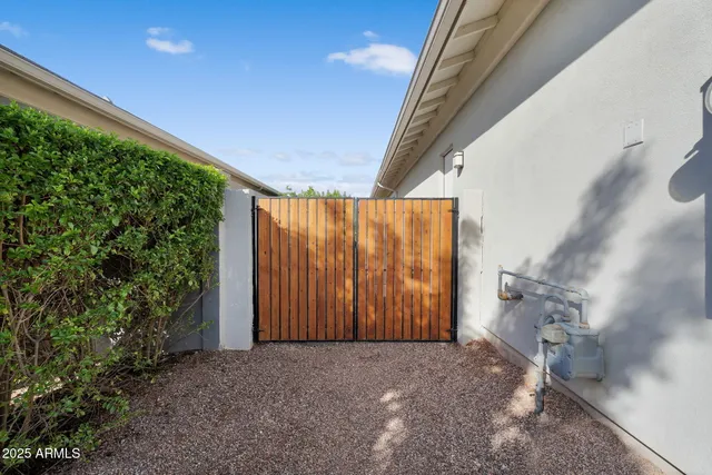 a large kitchen with stainless steel appliances kitchen island a large counter top a sink a stove and a refrigerator