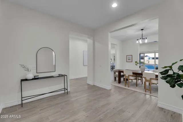 a living room with furniture a window and a chandelier