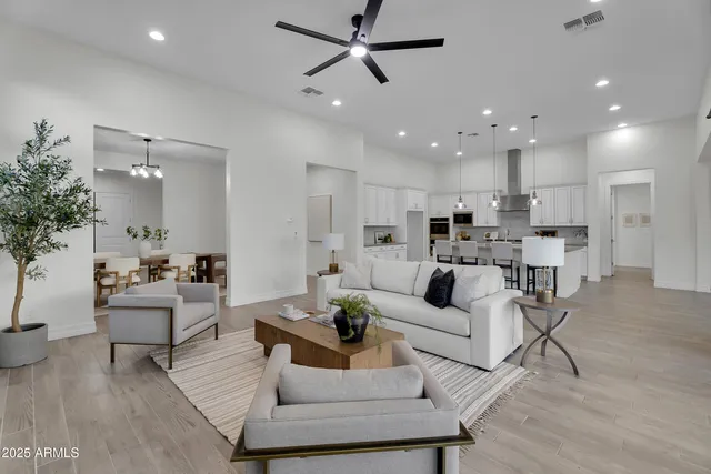 a spacious bathroom with a double vanity sink a large mirror and shower