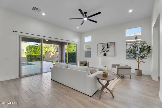 an empty room with a ceiling fan and wooden floor