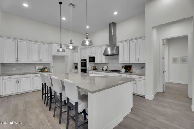 a bathroom with a sink a toilet a mirror a vanity and shower