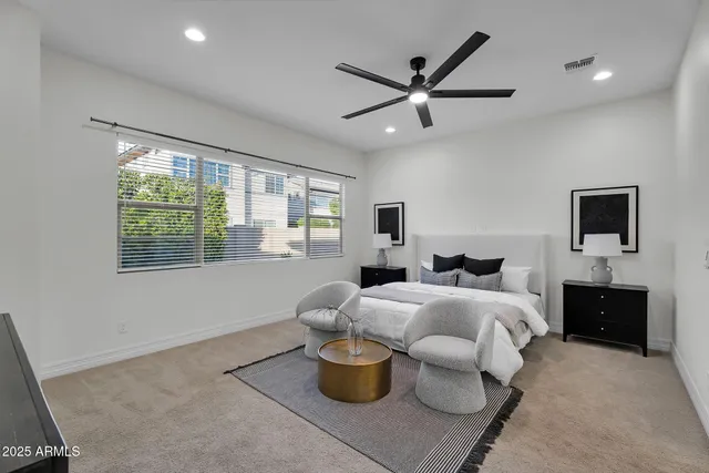 a front view of a house with a yard and potted plants