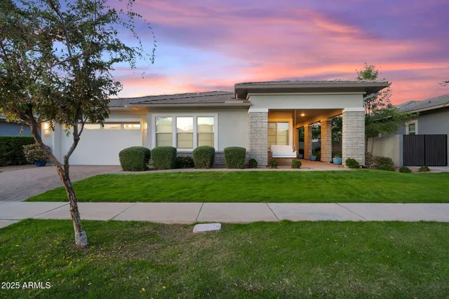 a view of a house with backyard and sitting area