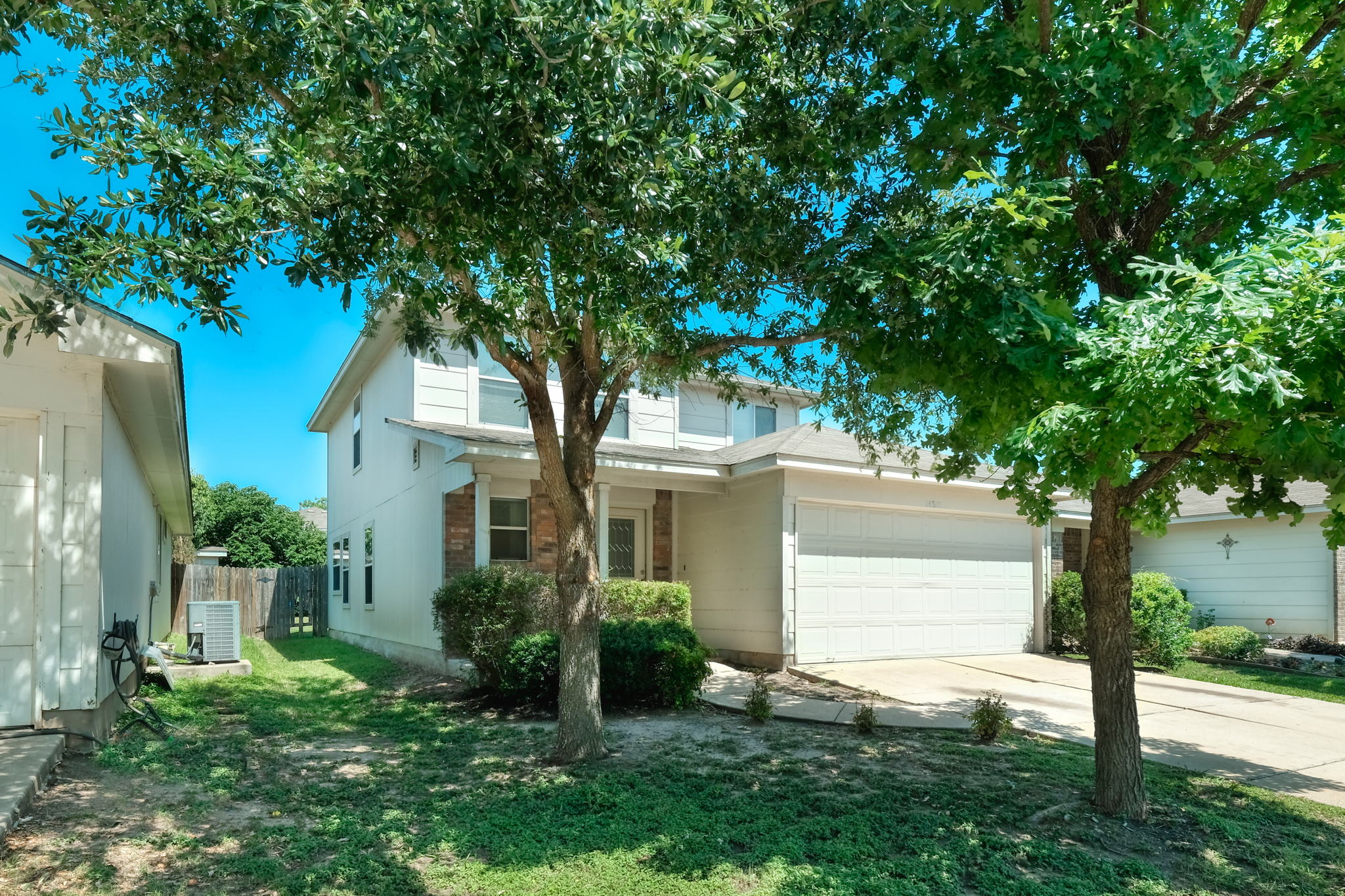 14312 Cummins Way Manor, TX 78653 - Photo 1 of 13 a front view of a house with a yard and a tree