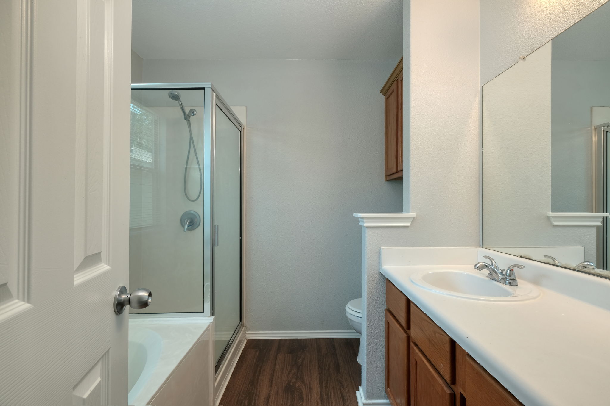 14312 Cummins Way Manor, TX 78653 - Photo 7 of 13 a bathroom with a sink toilet and shower