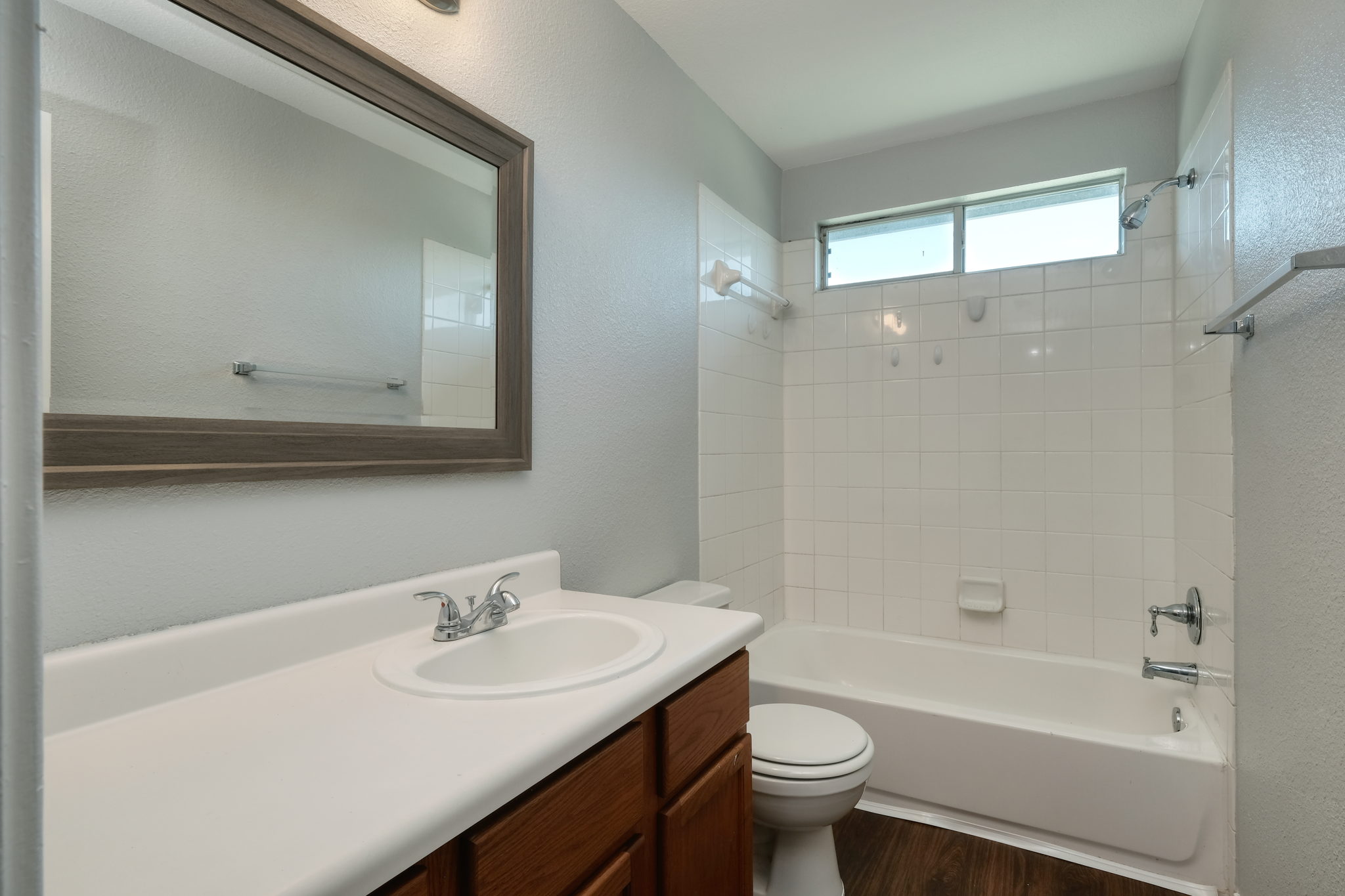 14312 Cummins Way Manor, TX 78653 - Photo 10 of 13 a bathroom with a sink a toilet a mirror and shower
