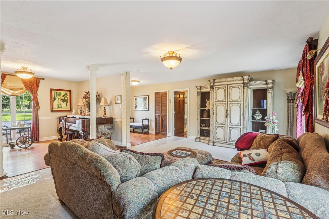 18336 Falling Water Road Strongsville, OH 44136 - Photo 8 of 50 Carpeted living room with ornate columns and wood finished floors