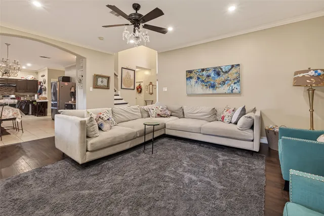a living room with furniture and a chandelier