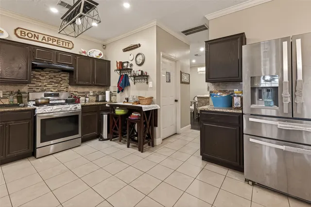 a kitchen with stainless steel appliances a stove sink and microwave