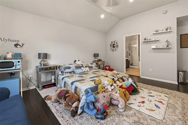 a bedroom with a bed and a dresser in it