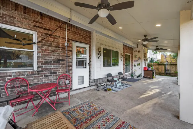 a view of a house with backyard porch and sitting area