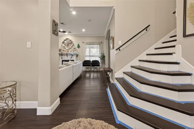 a view of entryway and hall with wooden floor