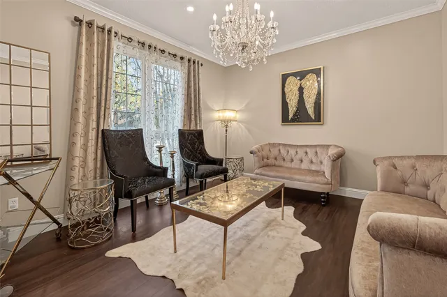 a living room with furniture a chandelier and a window