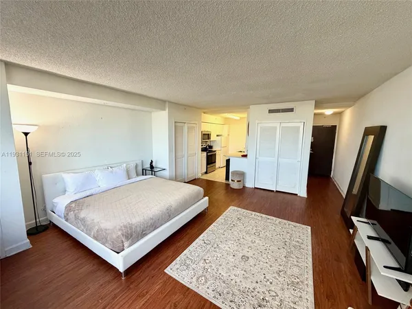 a bed room with a bed and a television