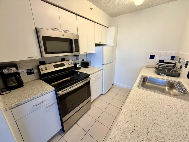 a kitchen with a stove and a microwave