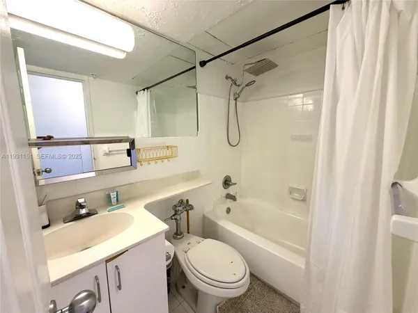 a bathroom with a sink toilet vanity and shower