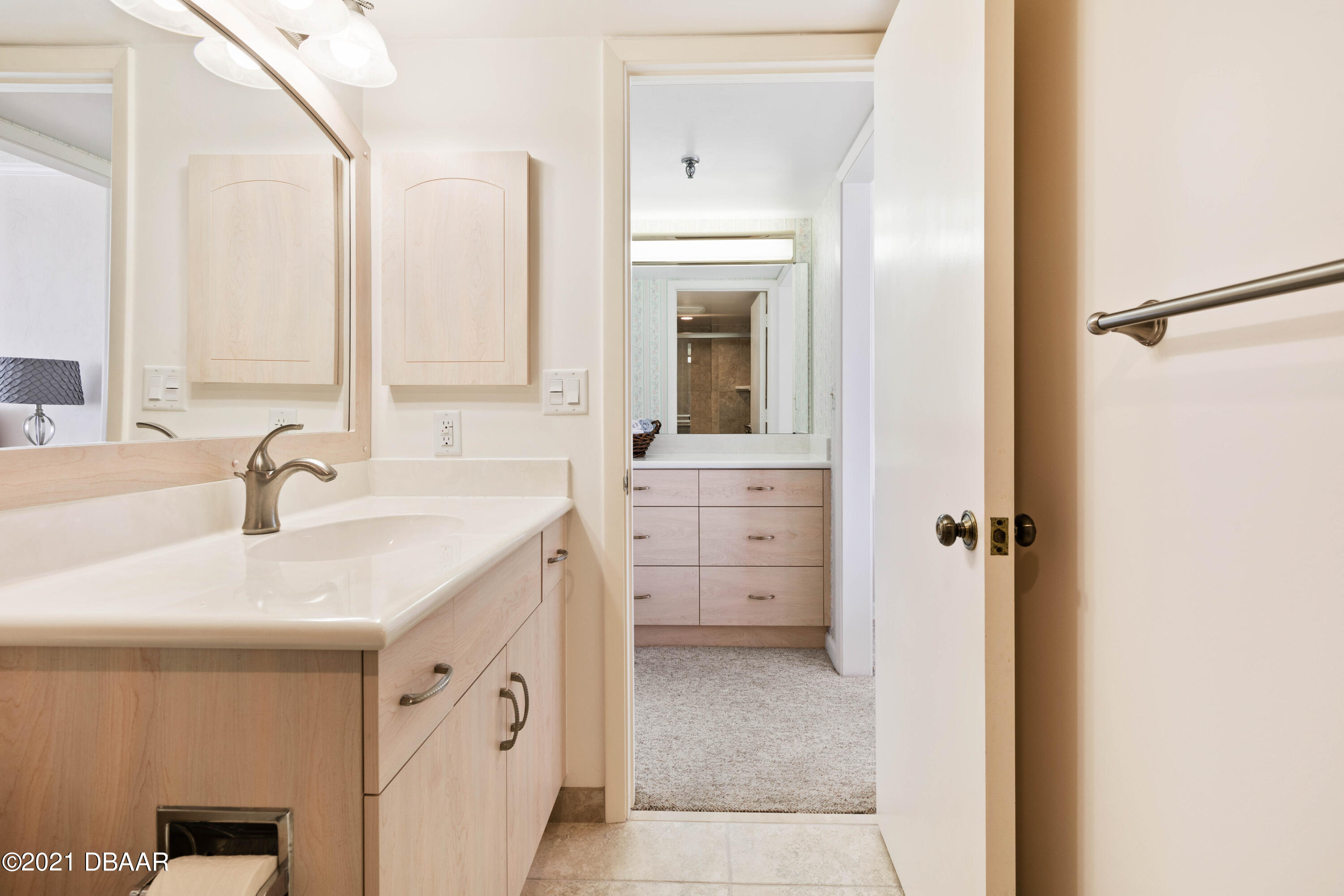 1051 Ocean Shore Boulevard, Unit 1102 Ormond Beach, FL 32176 - Photo 12 of 29 a bathroom with a sink and a mirror