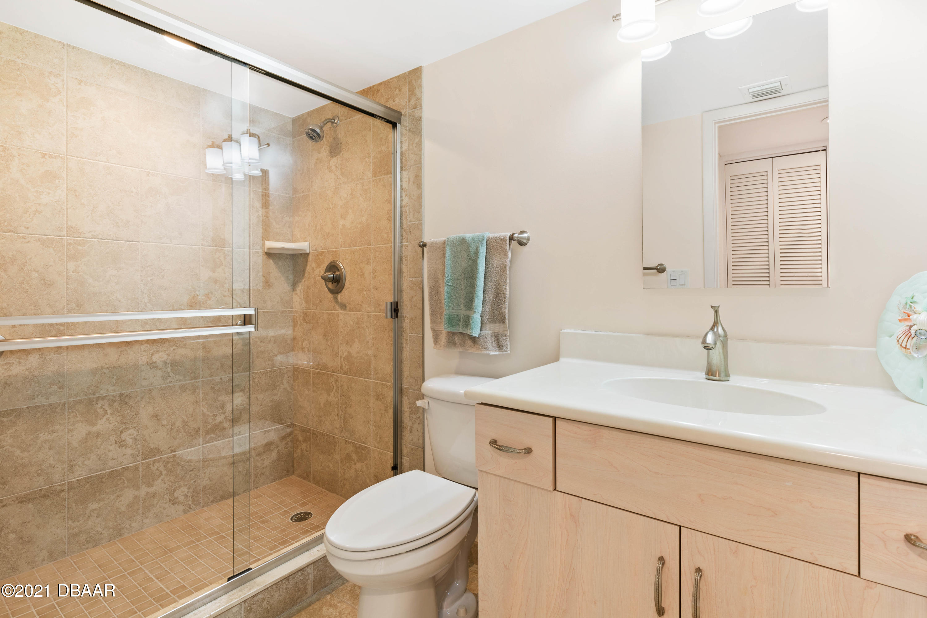 1051 Ocean Shore Boulevard, Unit 1102 Ormond Beach, FL 32176 - Photo 15 of 29 a bathroom with a sink toilet vanity and shower