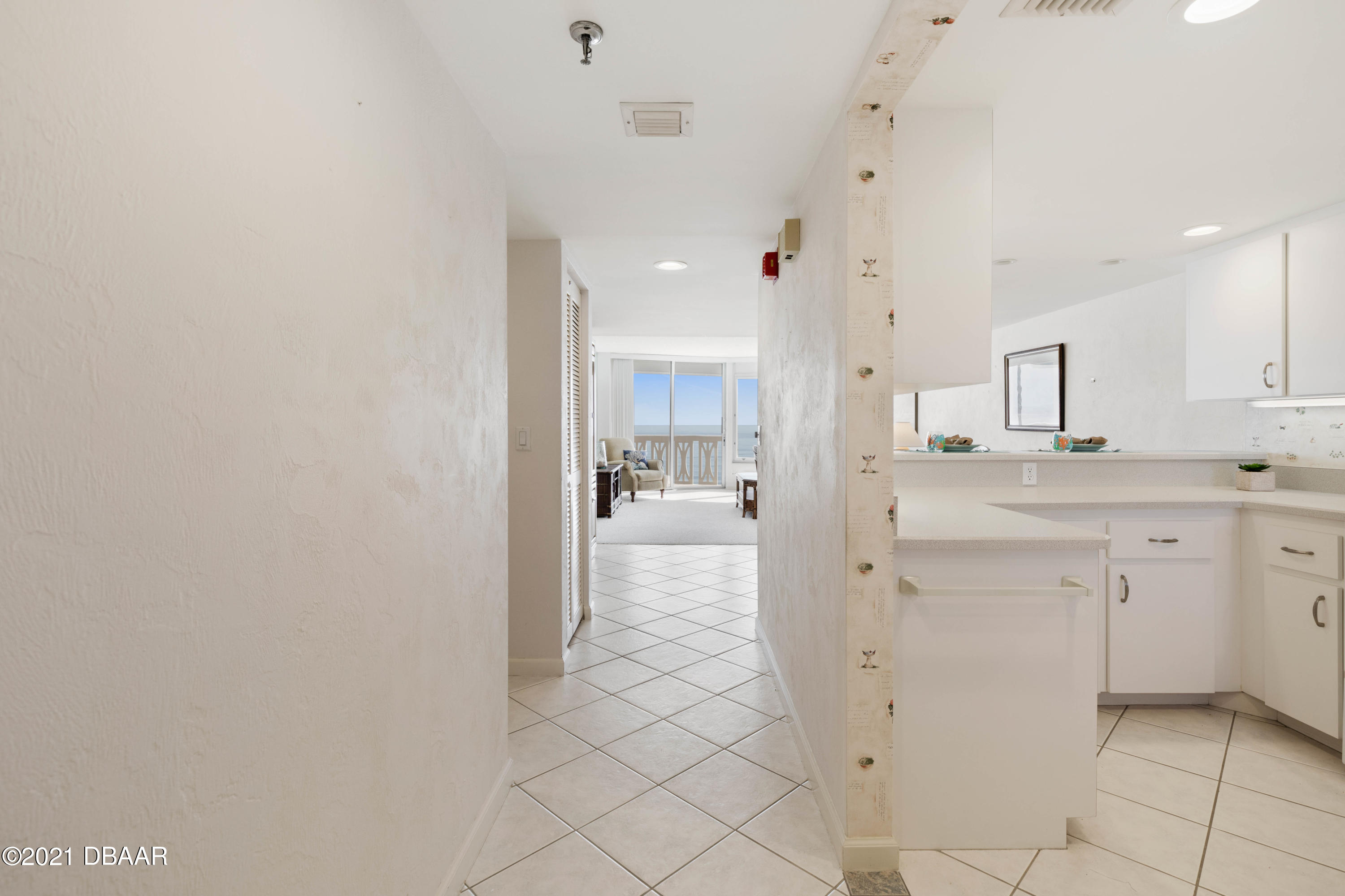 1051 Ocean Shore Boulevard, Unit 1102 Ormond Beach, FL 32176 - Photo 2 of 29 a bathroom with a sink a mirror and a shower