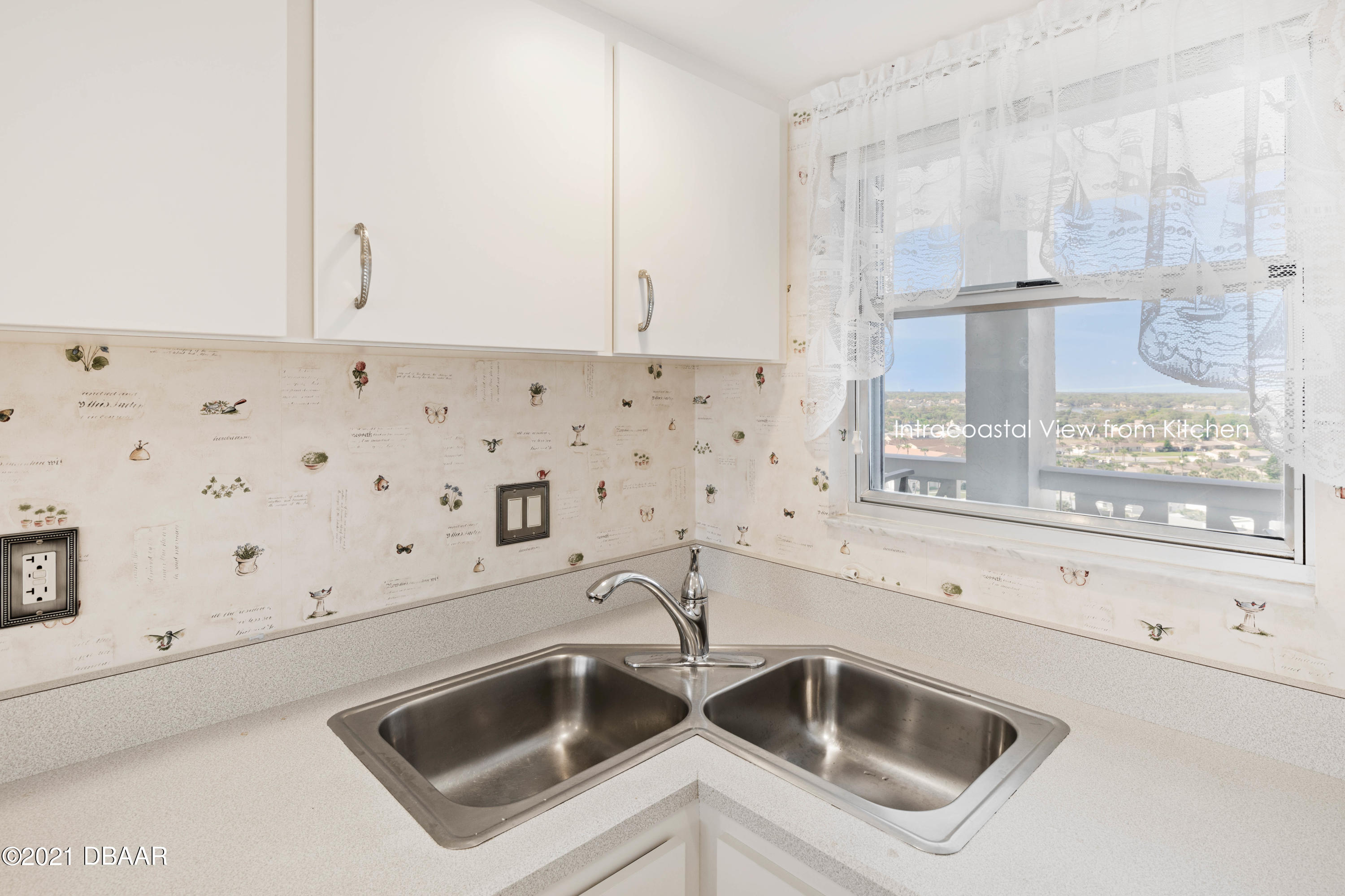 1051 Ocean Shore Boulevard, Unit 1102 Ormond Beach, FL 32176 - Photo 5 of 29 a close view of a sink and dishwasher in a kitchen