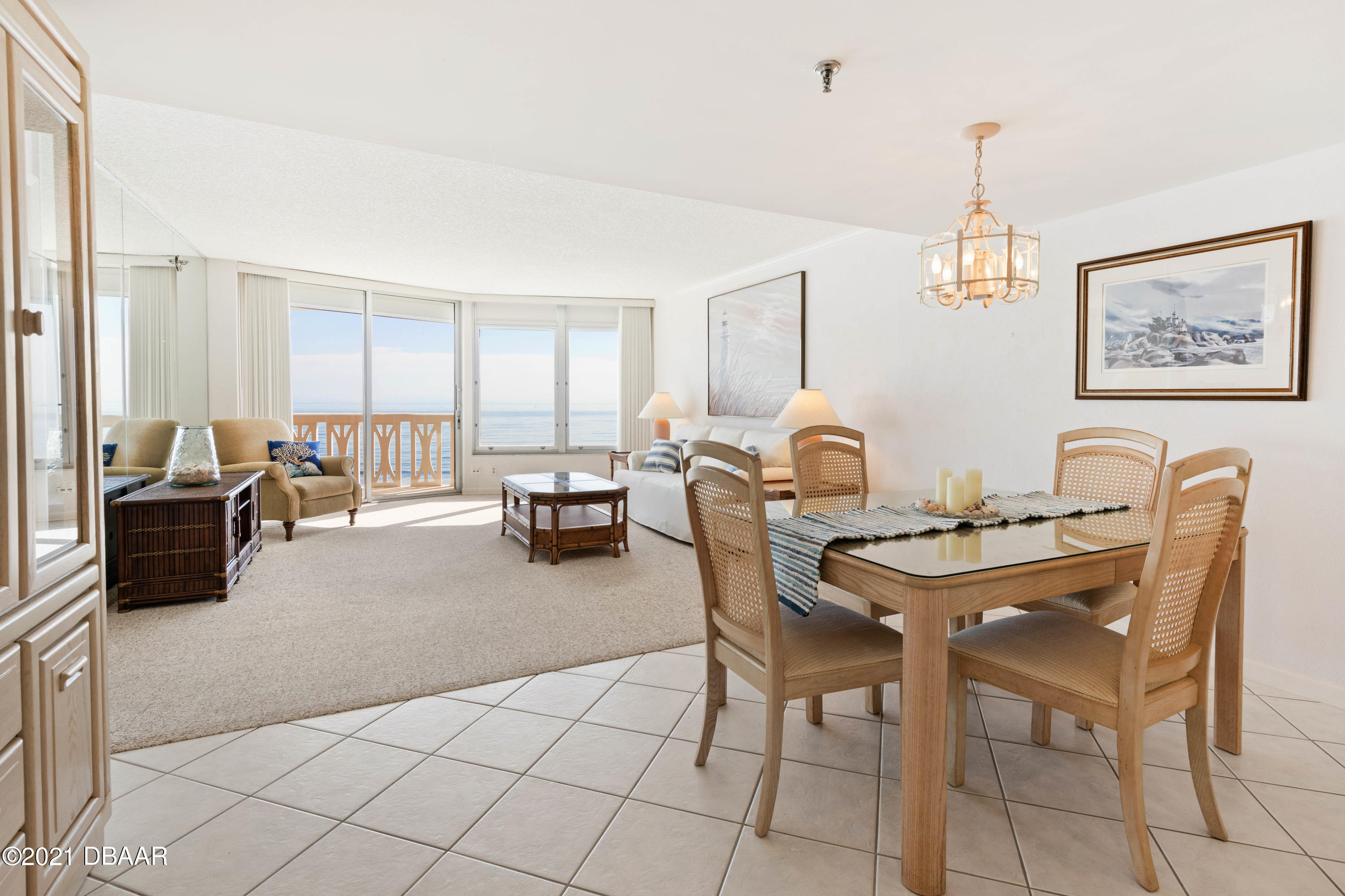 1051 Ocean Shore Boulevard, Unit 1102 Ormond Beach, FL 32176 - Photo 8 of 29 a dining room with furniture and a chandelier