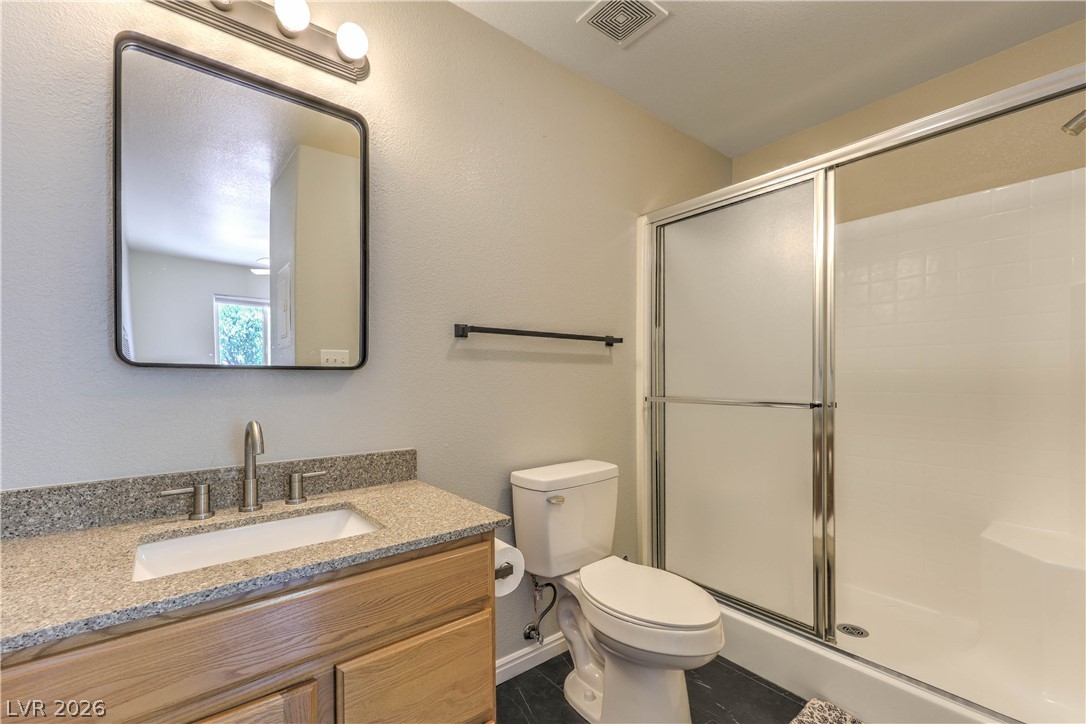348 Tres Palomas Street Overton, NV 89040 - Photo 34 of 41 Modern bath features a single vanity with granite counters and a practical shower enclosure.