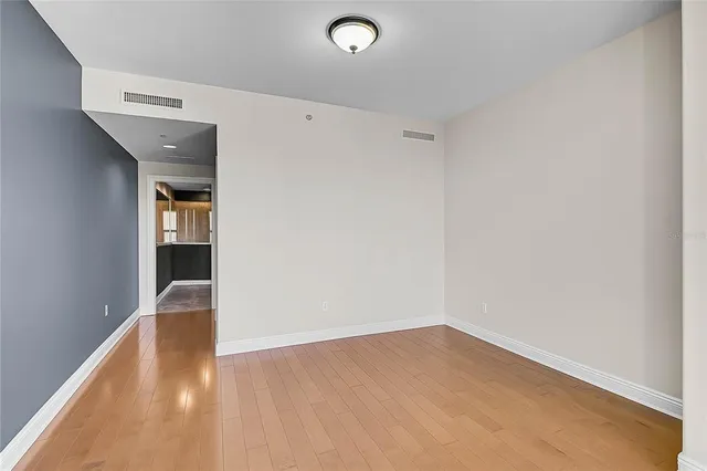 a bedroom with a bed and glass wall painting