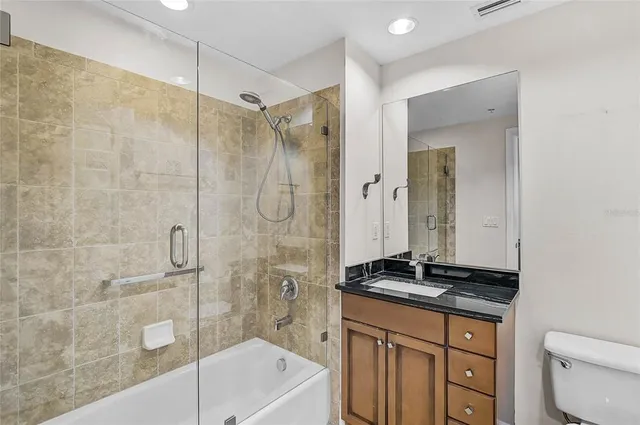 a kitchen with granite countertop stainless steel appliances a stove sink and microwave