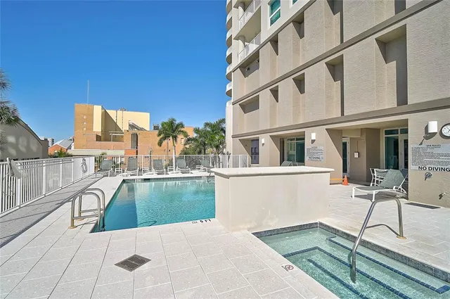 a view of a house with a swimming pool and sitting area