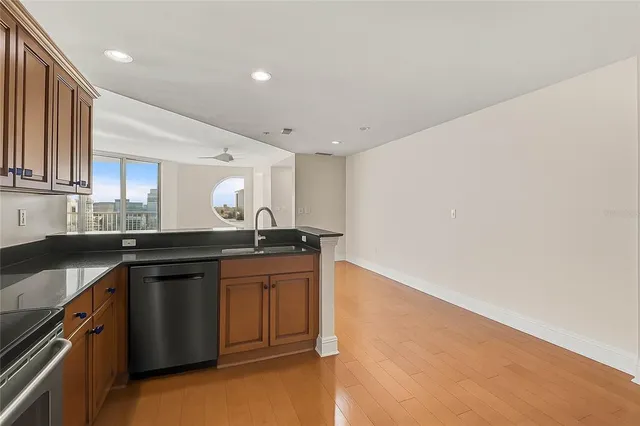a kitchen with granite countertop a sink and cabinets