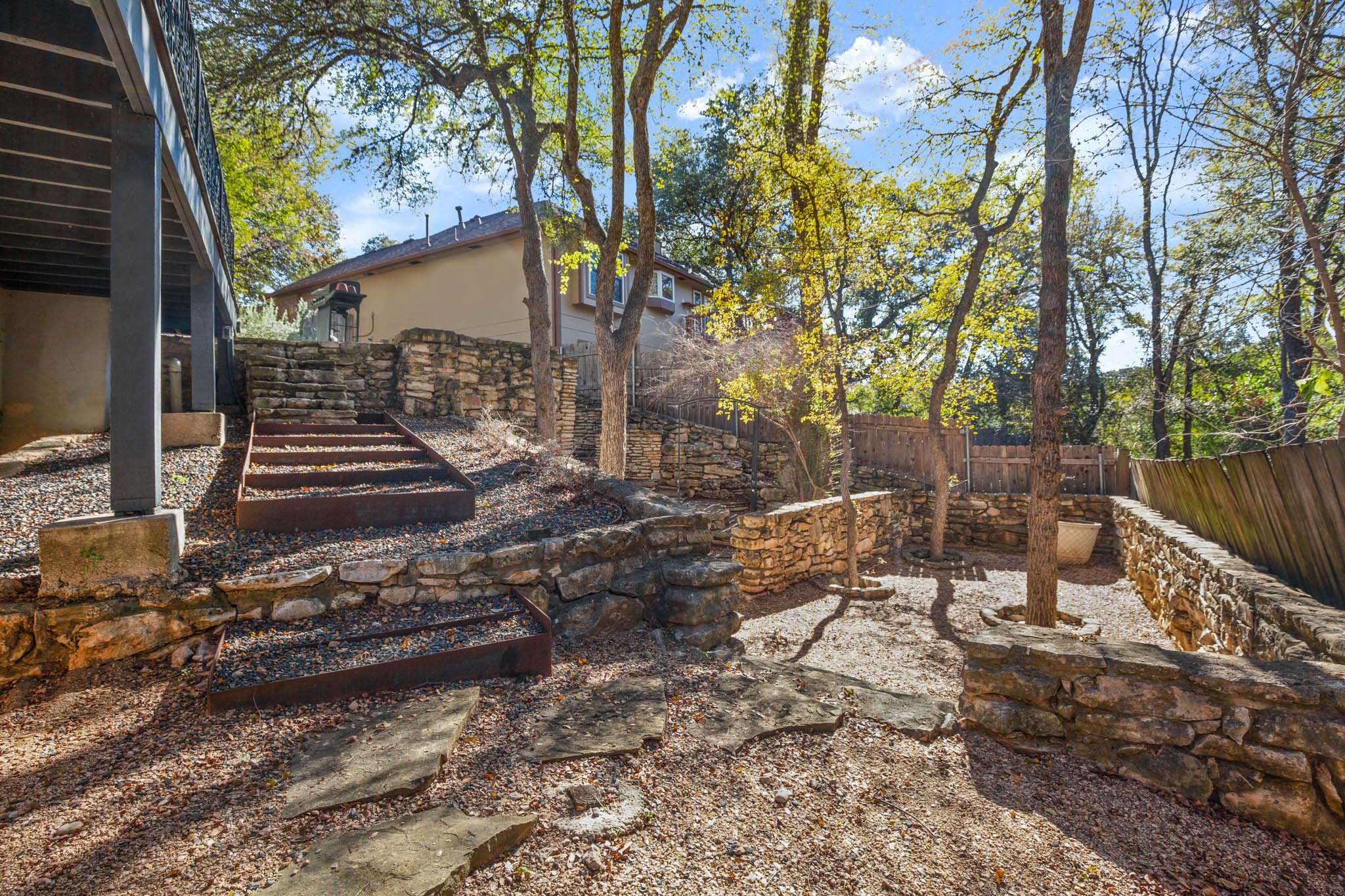 1601 Whitney Way Austin, TX 78741 - Photo 27 of 30 Terraced rock walls define this backyard sanctuary.