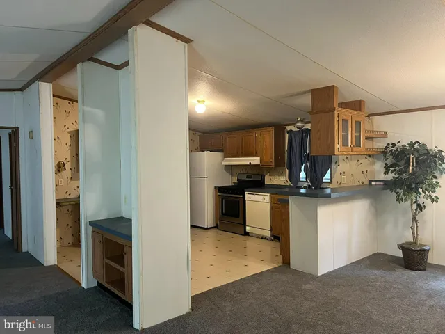 a kitchen with a refrigerator and white cabinets