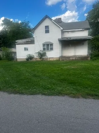 a view of a back yard of the house and car parked