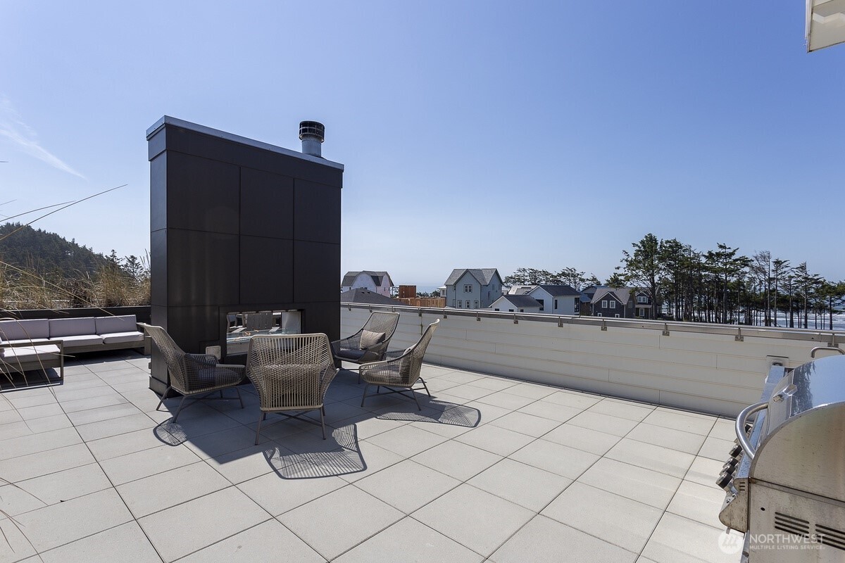 204 Market Street, Unit B Pacific Beach, WA 98571 - Photo 21 of 25 a terrace with outdoor seating and city view