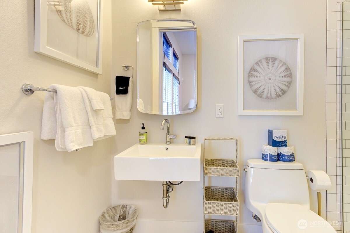 204 Market Street, Unit B Pacific Beach, WA 98571 - Photo 4 of 25 a bathroom with a sink toilet and mirror