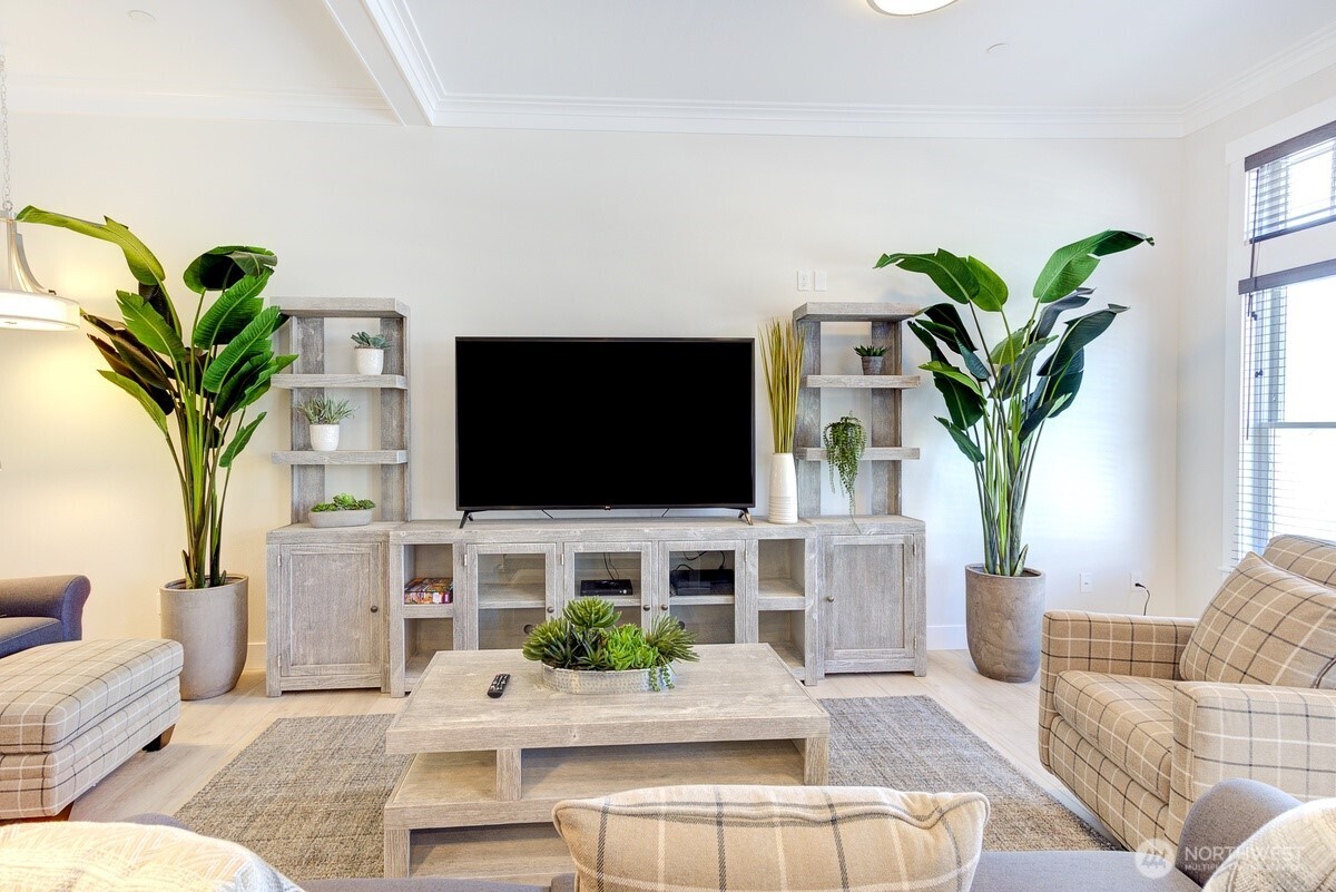 204 Market Street, Unit B Pacific Beach, WA 98571 - Photo 10 of 25 a living room with furniture potted plant and a flat screen tv