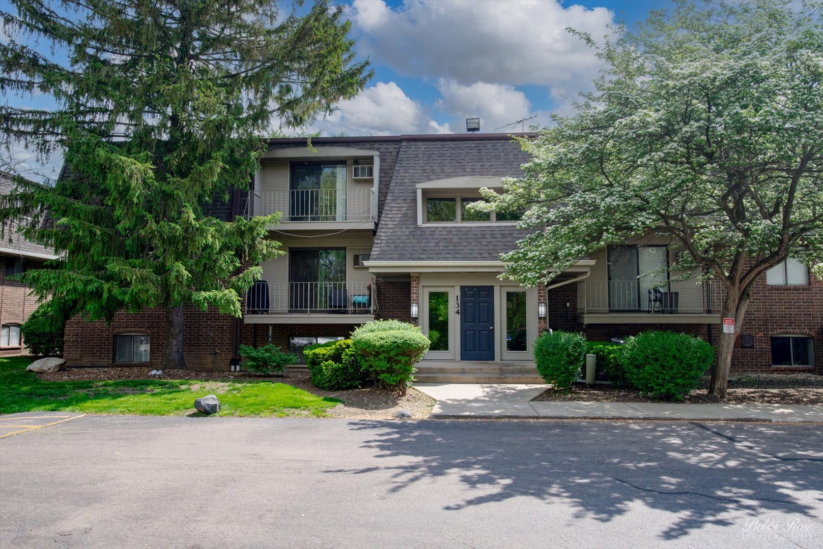 134 East Bailey Road, Unit J Naperville, IL 60565 - Photo 1 of 1 a front view of a house with a yard and a garage