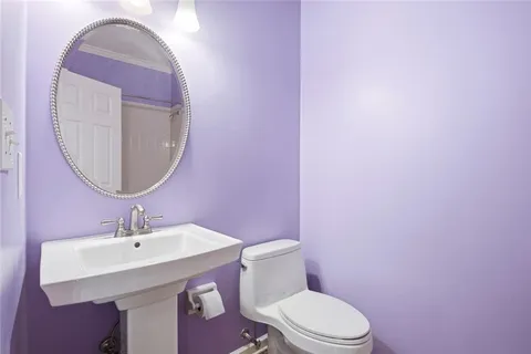 a bathroom with a sink mirror and toilet