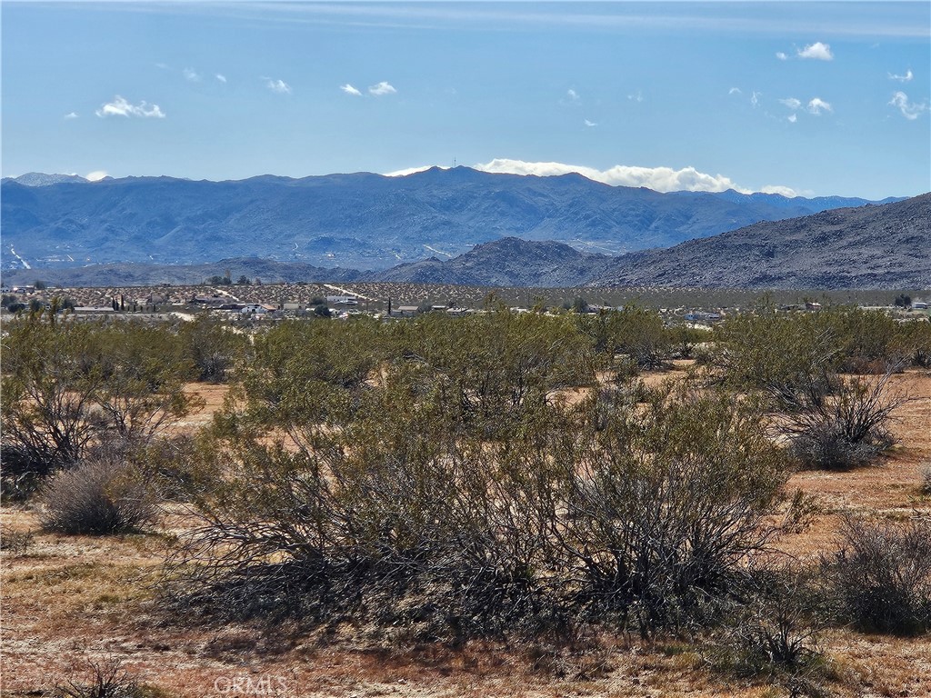 0 Avenida Del Sol Joshua Tree, CA 92252 - Photo 2 of 4 a view of a lush green hillside and houses