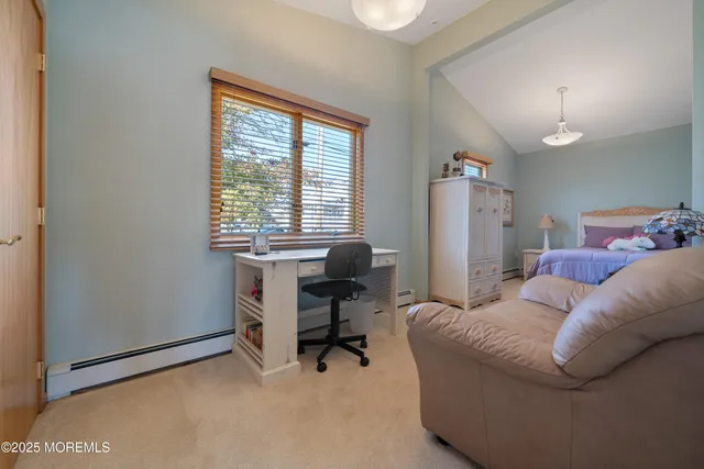 a livingroom with workspace and a window