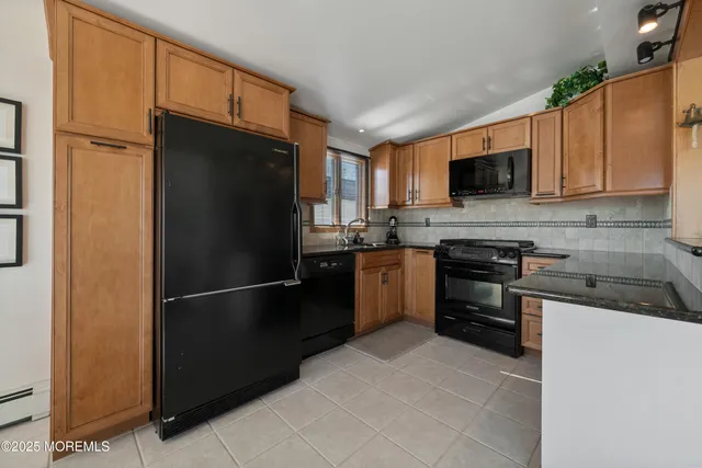 a kitchen with a refrigerator stove and microwave