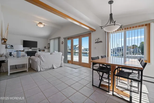 a living room with furniture a flat screen tv and a window