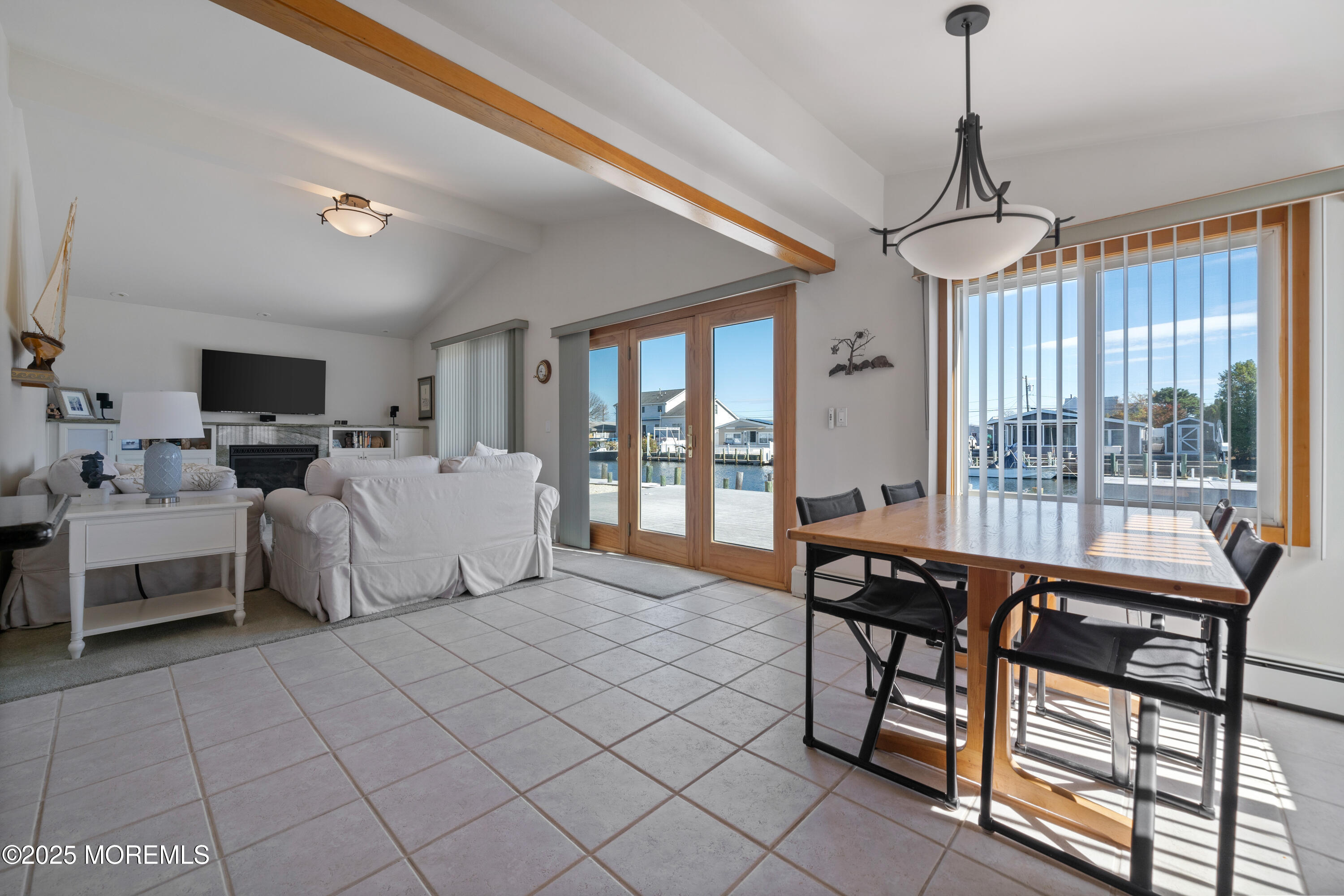 1211 Gemini Court Forked River, NJ 08731 - Photo 18 of 40 a living room with furniture a flat screen tv and a window