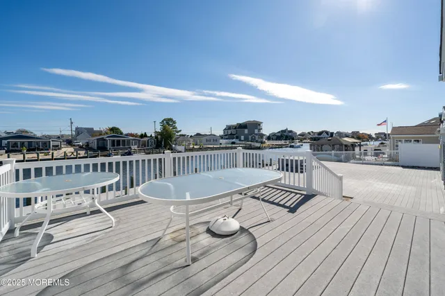 a view of roof deck with patio and wooden floor