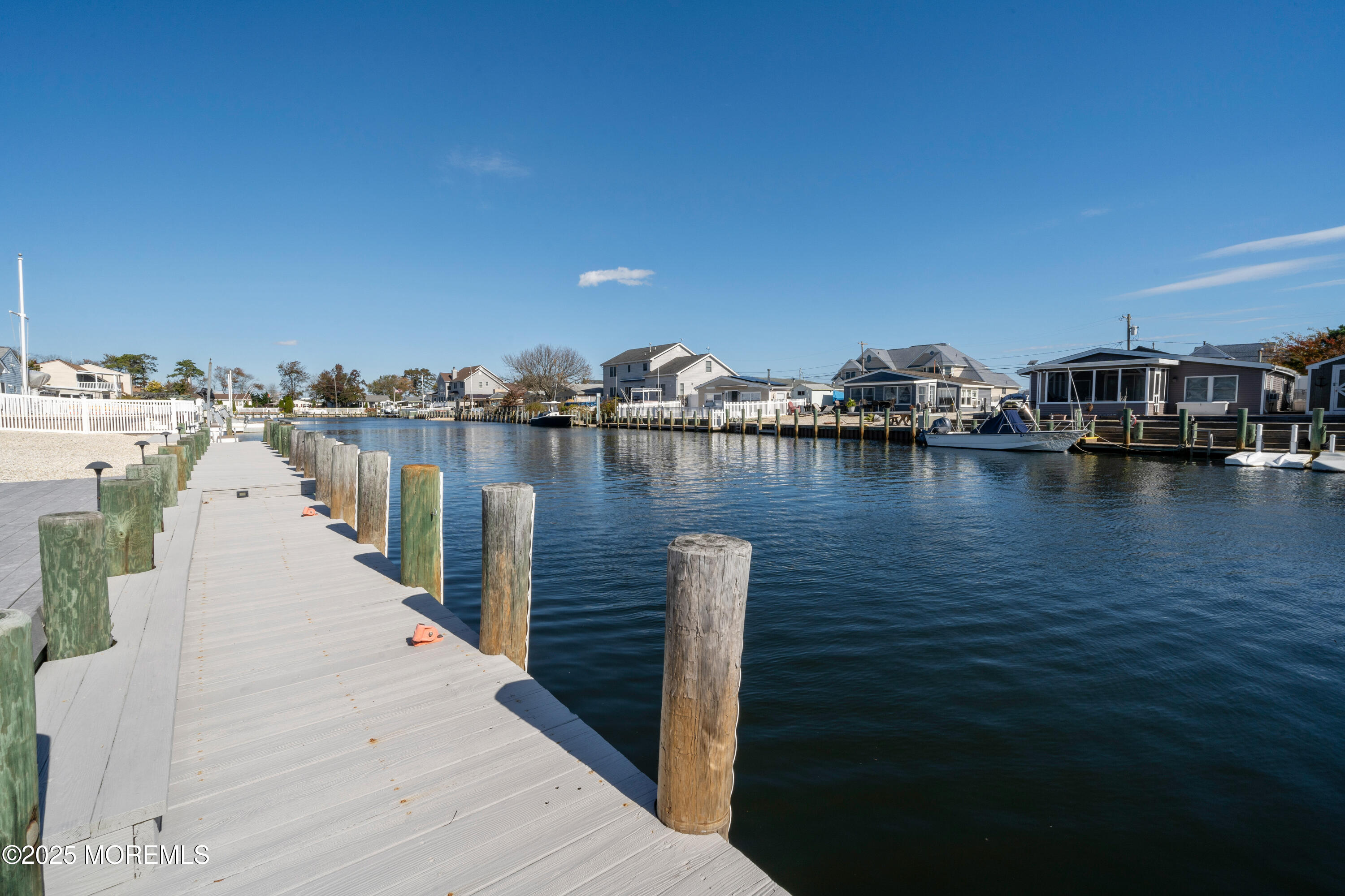 1211 Gemini Court Forked River, NJ 08731 - Photo 30 of 40 a view of a lake with boats and trees in the background